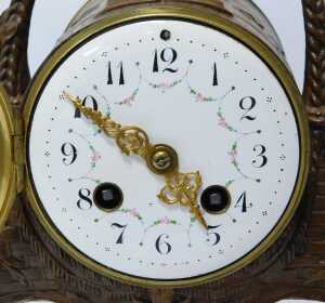 An early 20thC French figural mantel clock, with two latter day cherubs supporting a basket, the... - 2