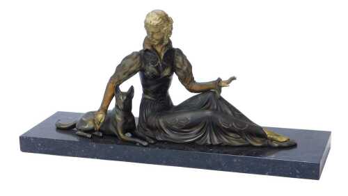A 20thC French Art Deco patinated figure of a seated woman with an Alsatian dog, with parcel...