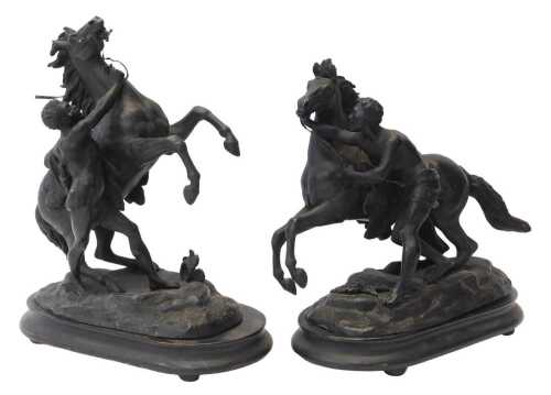 Two spelter Marley horses, raised on ebonised oval bases, on compressed bun feet, 39cm high, and...