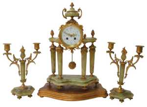 A late 19thC French three-piece clock garniture set, the drum head mantel clock with white...