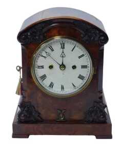 An early Victorian figured walnut cased bracket clock, with arched scroll top having carved...