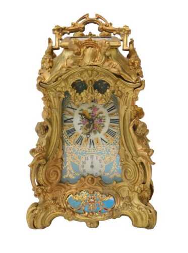 A 19thC French Louis XVI style ormolu mantel clock, with a highly ornate rococo-style case, and...