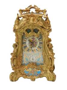 A 19thC French Louis XVI style ormolu mantel clock, with a highly ornate rococo-style case, and...