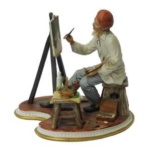 A Capodimonte porcelain figure, modelled as an artist seated at an easel, painting a still life,...