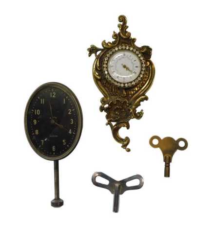 A Jaeger eight day car clock, the face of oval form, bearing Arabic numerals, 9cm high, on a...