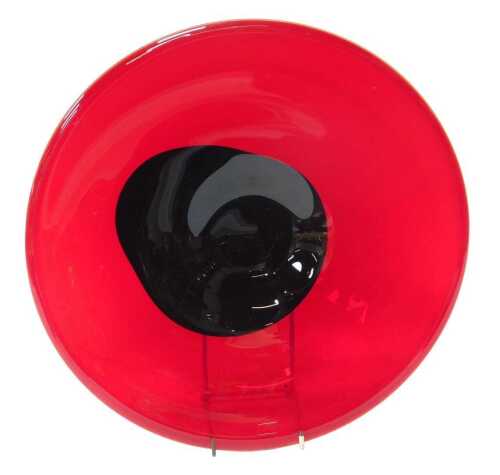 A late 20thC red glass dish, with central black abstract decoration, 34cm diameter.
