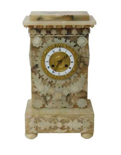 A French Empire style alabaster mantel clock, the brass dial bearing a white enamel chapter ring...