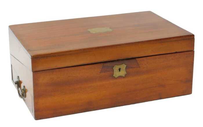 A Victorian mahogany writing slope, the hinged lid bearing an indistinctly named brass cartouche...