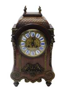 A late 19thC French mahogany cased mantel clock, the circular brass dial with raised white and...