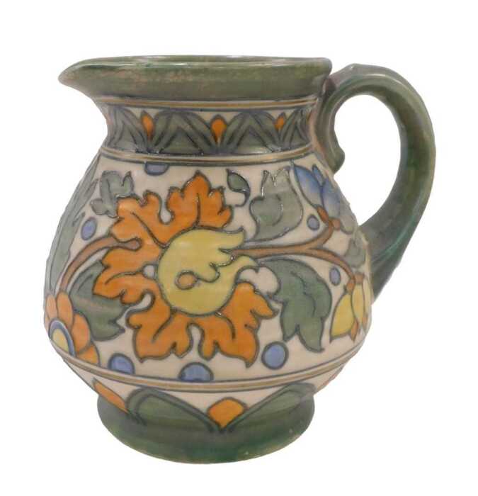 A Crown Ducal Charlotte Rhead pottery floral pattern jug, with plain spout, textured handle,...