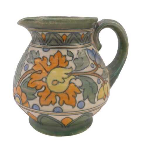 A Crown Ducal Charlotte Rhead pottery floral pattern jug, with plain spout, textured handle,...