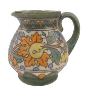 A Crown Ducal Charlotte Rhead pottery floral pattern jug, with plain spout, textured handle,...