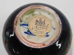 A Moorcroft pottery flambe Leaf and Berry pattern squat vase, of bellied circular form on... - 2