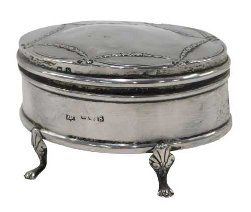 A George V silver jewellery casket, of oval form, with an outer raised bell flower garland...