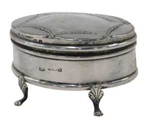A George V silver jewellery casket, of oval form, with an outer raised bell flower garland...