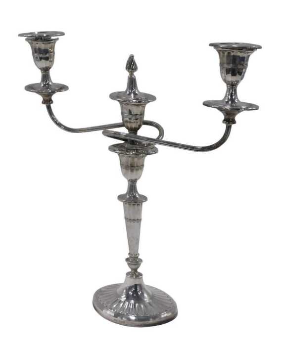 An Elizabeth II three branch candelabrum, with one flame finial, triple urn dish holders,...