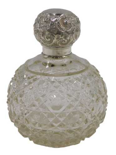 An Edward VII cut glass silver topped perfume bottle, of bulbous form, with a repeat hobnail cut...