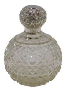 An Edward VII cut glass silver topped perfume bottle, of bulbous form, with a repeat hobnail cut...