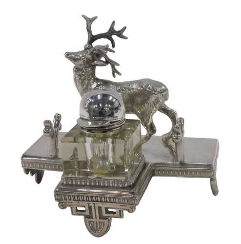 An Edwardian novelty ink stand stag, on a T shaped base, with space for pen, on triple mitre...