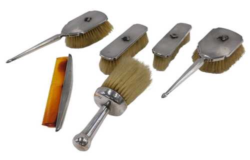 A George V silver Art Deco five piece dressing table set, comprising two hairbrushes, two...