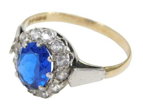 A 9ct gold cluster ring, the central treated dark blue stone in a claw setting, surrounded by...
