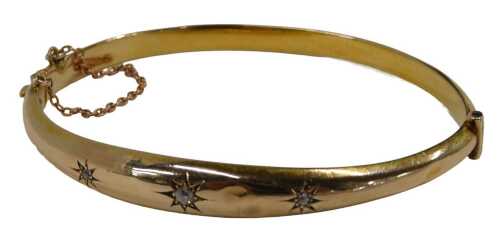 A diamond set half hinged bangle, set with three star illusion set old mine cut diamonds, on a...