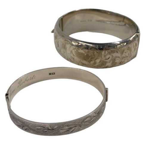 Two silver half hinged bangles, comprising one with brushed moulded leaf decoration, 6cm...