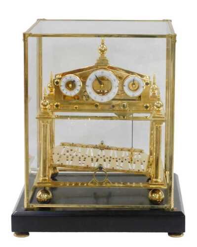 A 20thC Congreve rolling ball clock, in a highly elaborate gilt brass case, surmounted by an orb...