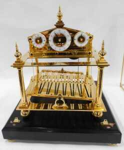 A 20thC Congreve rolling ball clock, in a highly elaborate gilt brass case, surmounted by an orb... - 2