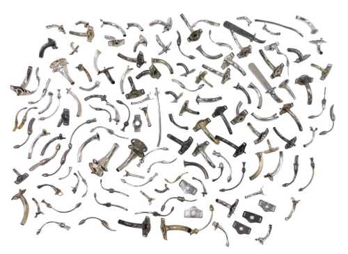 Various medical tracheostomy tubes, of shaped form with varying attachments, in white metal,...