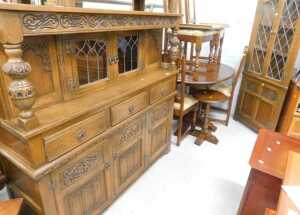 An Old Charm style linen fold dining room suite, comprising court cupboard, D end dining table,...