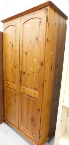 A two door pine wardrobe.
