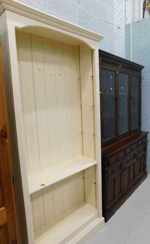 A cream painted open bookcase, and an Old Charm style display cabinet, with astragal glazed...