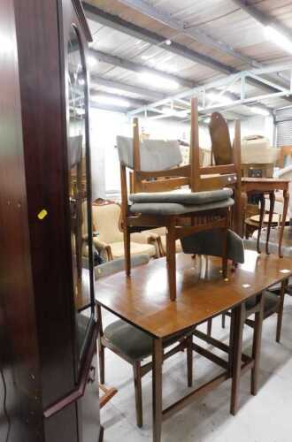 A teak gate leg table and four chairs, each with overstuffed seats, a nest of tables, and a...