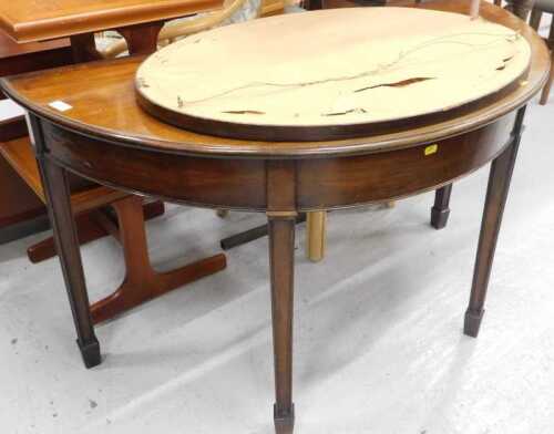 An Edwardian mahogany D end table, and an oval hanging mirror.