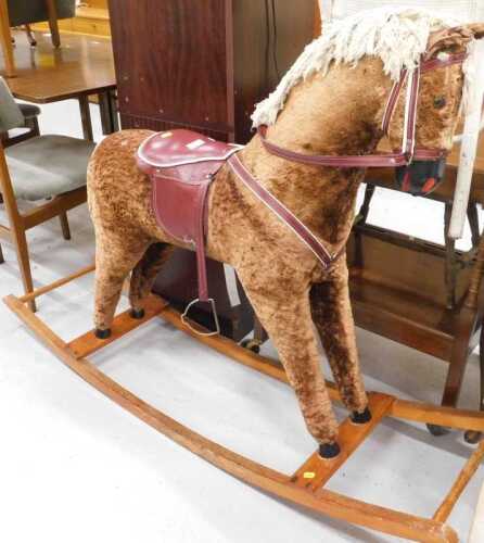 A modern rocking horse, on lightwood rocker base, 108cm high.