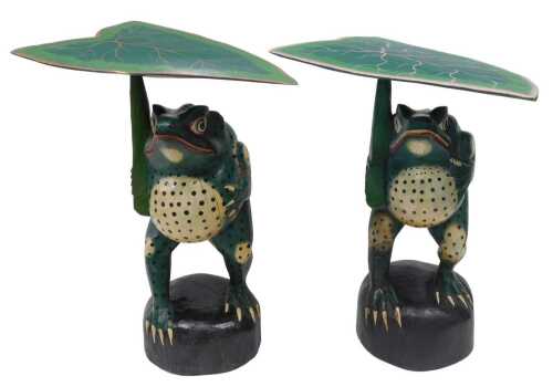 Two large late 20thC painted standing wooden frog figures, with additional lily pads, profusely...