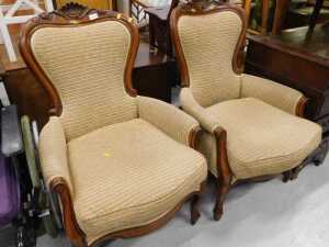A pair of Victorian style walnut spoonback chairs, with carved shell backs, shaped arms and...