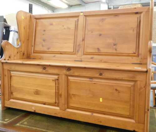 A pine two seater monk's bench, with plain panelled front.