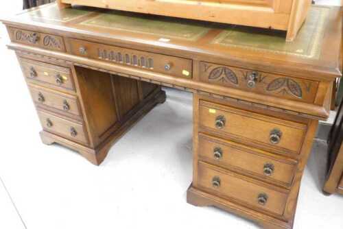 An Old Charm style twin pedestal writing desk, with three part tooled green leather top, raised...