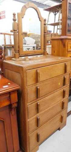 A mid 20thC oak Epstein style chest, of five long drawers, and a pine table mirror. (2)