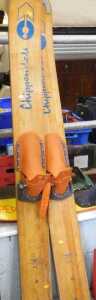 A pair of Chippendale Falcon jump skis, with fixed feet sections and wooden bases, partially...