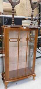 A walnut display cabinet, and two tripod tables.