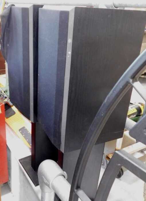 Two freestanding speakers, in part wooden surrounds.
