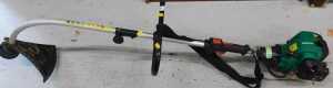 A Qualcast petrol strimmer.