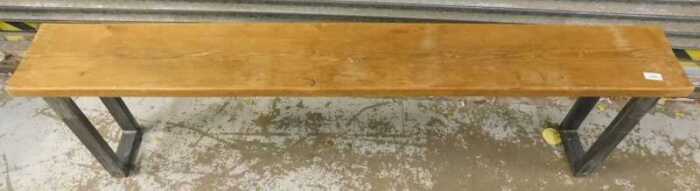 A pine bench, on metal legs.