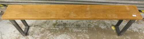 A pine bench, on metal legs.