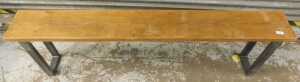 A pine bench, on metal legs.