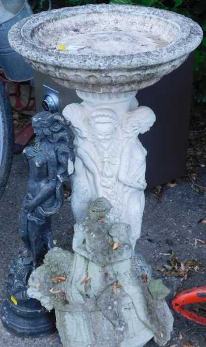 A classical design bird bath, a garden statue of a lady, and another.