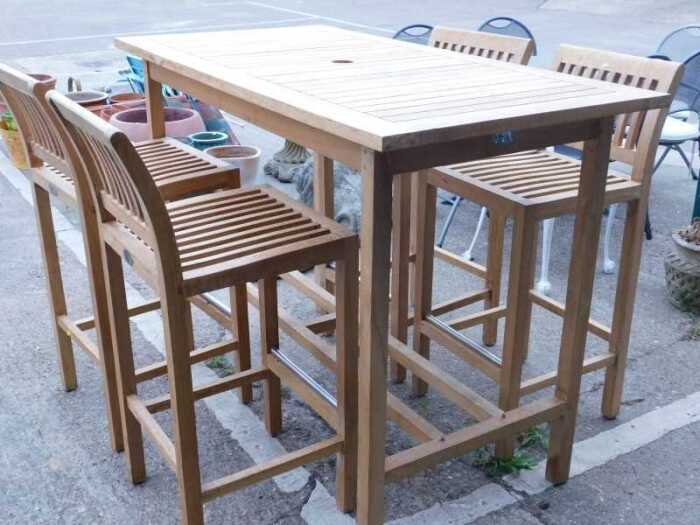A Lifestyle Teak slatted high rectangular exterior bar table, with space for parasol, and four...